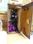 A vintage Beck laboratory microscope in a wooden case