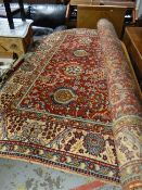 An excellent red ground floral Persian carpet