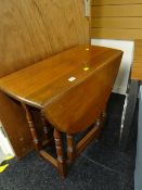 A neat light oak drop leaf gate-leg table
