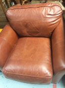 A modern dark tan leather club-style chair