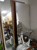 A large metal framed IKEA mirror together with a parcel of other tall wall mirrors