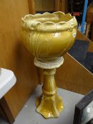 A glazed pottery jardiniere & stand