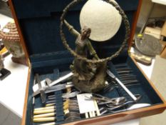An Art Deco-style globular figural table lamp & a part cutlery set in a case