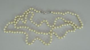 A LONG STRAND OF MIKIMOTO CULTURED PEARLS of uniform shape, approx 100-120 pearls total, white metal