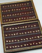 TWO DISPLAY CASES OF YELLOW METAL AVIATION BADGES with printed titles