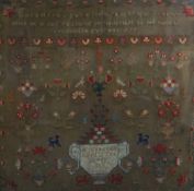 A MID NINETEENTH CENTURY CROSS STITCH SAMPLER in oak frame with Welsh verse to top, decorated with