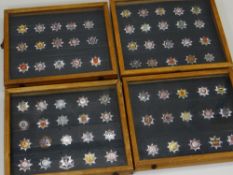 FOUR DISPLAY CASES OF BRITISH FIRE BRIGADE BADGES
