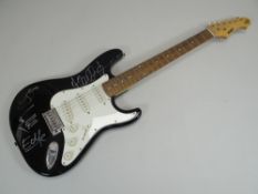 AN ELECTRIC GUITAR SIGNED BY THE BAND MEMBERS OF U2 with certificate of authenticity from '