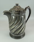 A REED & BARTON WHITE METAL ICE-PITCHER with ceramic liner within the swirl decorated outer, 30cms