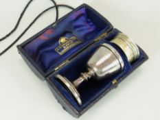 A CASED SILVER TRAVELLING COMMUNION SET comprising lidded chalice and pyx, both with engraved
