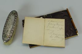 A STERLING SILVER DRESSING-TABLE BRUSH with enamel floral border and inscribed 'Nina', together with