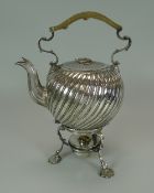 A VICTORIAN SILVER SPIRIT KETTLE of globular form with raised swirl decoration and on three