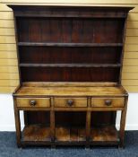 A NINETEENTH CENTURY WELSH DRESSER OF SMALL PROPORTIONS raised over an open planked platform-base,