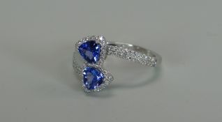A MODERN 18K WHITE GOLD, TANZANITE & DIAMOND RING