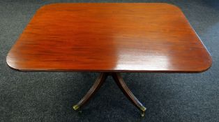 A MAHOGANY TILT-TOP BREAKFAST TABLE of rounded rectangular form and on a reeded four-spoke base with