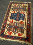 A BLUE & RED GROUND PATTERNED RUG 157 x 100cms