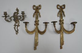 A PAIR OF GILT METAL WALL SCONCES with two branches and of ribbon-form, 50cms high and another,