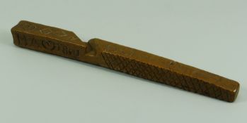 A FRUITWOOD TREEN KNITTING SHEATH with primitive cross-scratching, heart motifs and initialled '