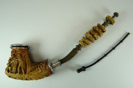 A LARGE SILVER MOUNTED CONTINENTAL CARVED SMOKING-PIPE in two sections with pipe-cleaner, the stem