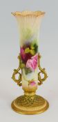 A ROYAL WORCESTER TWIN HANDLED VASE on a spreading circular foot with lattice work moulding, the