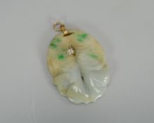 A CARVED JADE PENDANT WITH DIAMOND SOLITAIRE