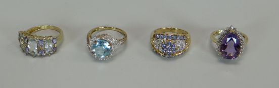 FOUR MODERN DRESS RINGS SET IN 9CT YELLOW GOLD