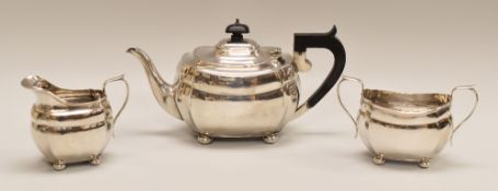 A THREE-PIECE FACETED SILVER TEA SET comprising teapot, cream jug & sugar basin, all of oval form on