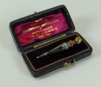 AN ENAMELLED & BEJEWELED ANTIQUE BROOCH in the form of a Scottish dirk set in silver (consign