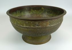 A BRONZE EASTERN FOOTED BOWL with profuse floral sgraffito decoration, 28cms diam
