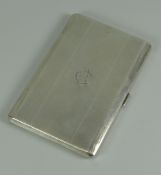 A MACHINE TURNED SILVER CIGARETTE CASE with a monogrammed lid, Birmingham 1935, 5.8oz