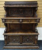 A NINETEENTH CENTURY CONTINENTAL CARVED BUFFET SIDEBOARD heavily carved with floral motifs,