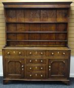 A NINETEENTH CENTURY NORTH WALES OAK WELSH DRESSER composed of a base with four centre drawers, a