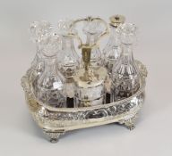 A GEORGIAN SILVER CRUET SET of seven bottles and being basin-form on four claw feet and having