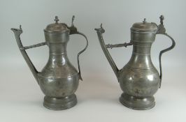 A NEAR PAIR OF MID-EIGHTEENTH CENTURY SWISS PEWTER 'STEGKANNE' JUGS of footed form with bulbous