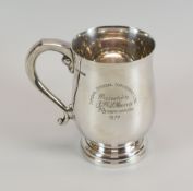 A SILVER MUG of footed form with scroll handle bearing presentation inscription, Sheffield 1970