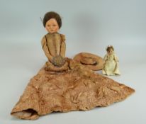 A VICTORIAN PAPIER-MACHE DOLL in long silk dress and bonnet, together with a miniature bisque head