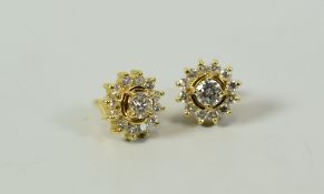 A PAIR OF PRETTY FLORAL DIAMOND EARRINGS the centre diamonds approx 0.25ct each in 18ct yellow gold