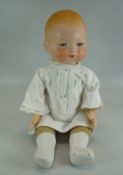 AN ARMAND MARSEILLE PORCELAIN HEADED DOLL with painted face and opening and closing eyes,
