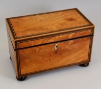A GEORGE III SATINWOOD & ROSEWOOD INLAID TEA-CADDY of simple rectangular form on corner bun-feet,