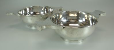 A PAIR OF SILVER-PLATED QUAICH BOWLS with twin handles, 17.5cms diam (excl. handles)