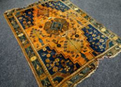 A WELL WORN BLUE & ORANGE PATTERNED RUG 200 x 147cms