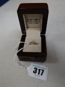 Diamond solitaire eighteen carat gold ring with diamond shoulders