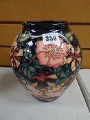 Modern Moorcroft tube lined floral vase of baluster form, signed with initials and dated '93