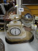 French marble clock in a glass dome on stand