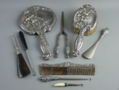A SILVER BACKED DRESSING MIRROR, HAND BRUSH & COMB with elaborate raised floral decoration,