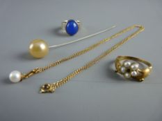 A GOLD 'HAND' DRESS RING, the two hands holding a cluster of five seed pearls and with tiny precious