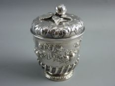 A CONTINENTAL SILVER POT with a short pedestal and having raised fruit and ribbon decoration and a