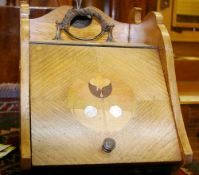 AN OAK ART NOUVEAU COAL SCUTTLE with interior liner and scoop, the lidded section with multi-wood