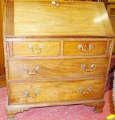 A NEAT GEORGIAN MAHOGANY BUREAU, the slope front revealing the well fitted interior and having two