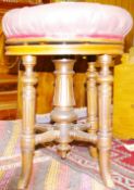 A WALNUT REVOLVING RISE & FALL PIANO STOOL stamped 'Brooks', having a button upholstered leather